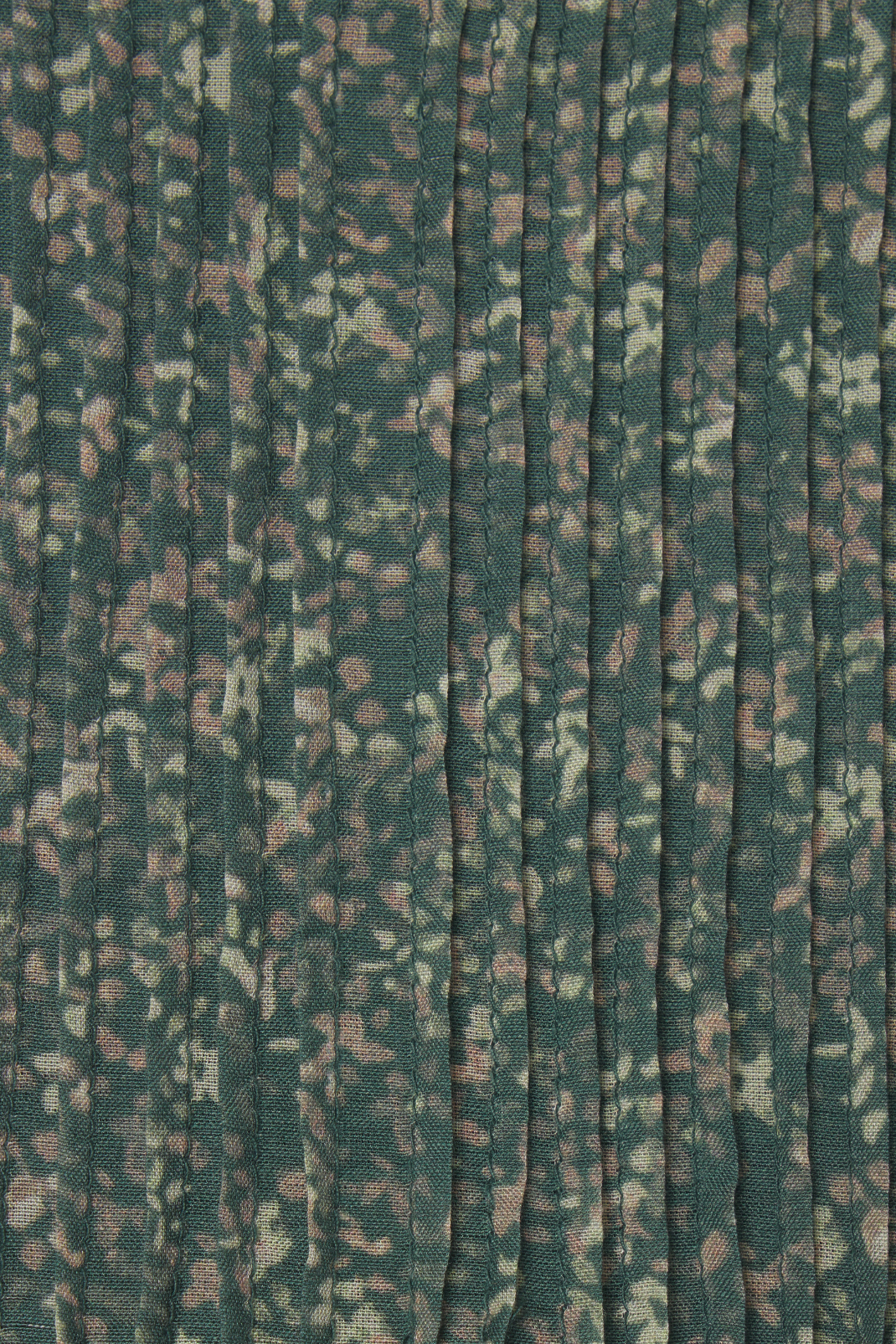 Textured fabric with a subtle pattern on a green background