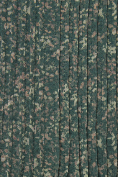 Textured fabric with a subtle pattern on a green background