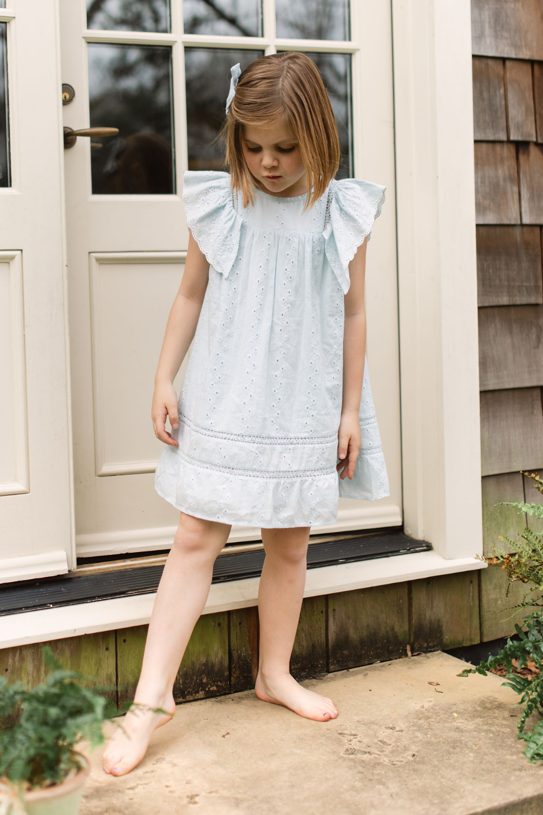 Little girl in light blue eyelet dress