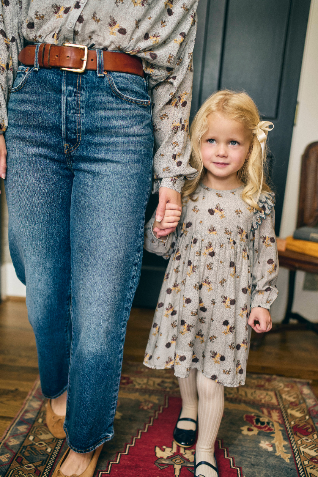 Woman and young girl wearing a matching floral print top and dress
