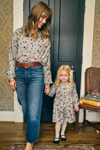 Woman and child holding hands in a home setting