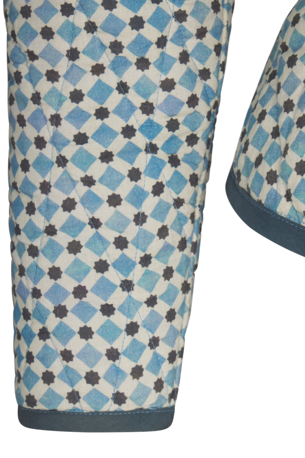 Close-up of a patterned fabric with blue and beige geometric design.