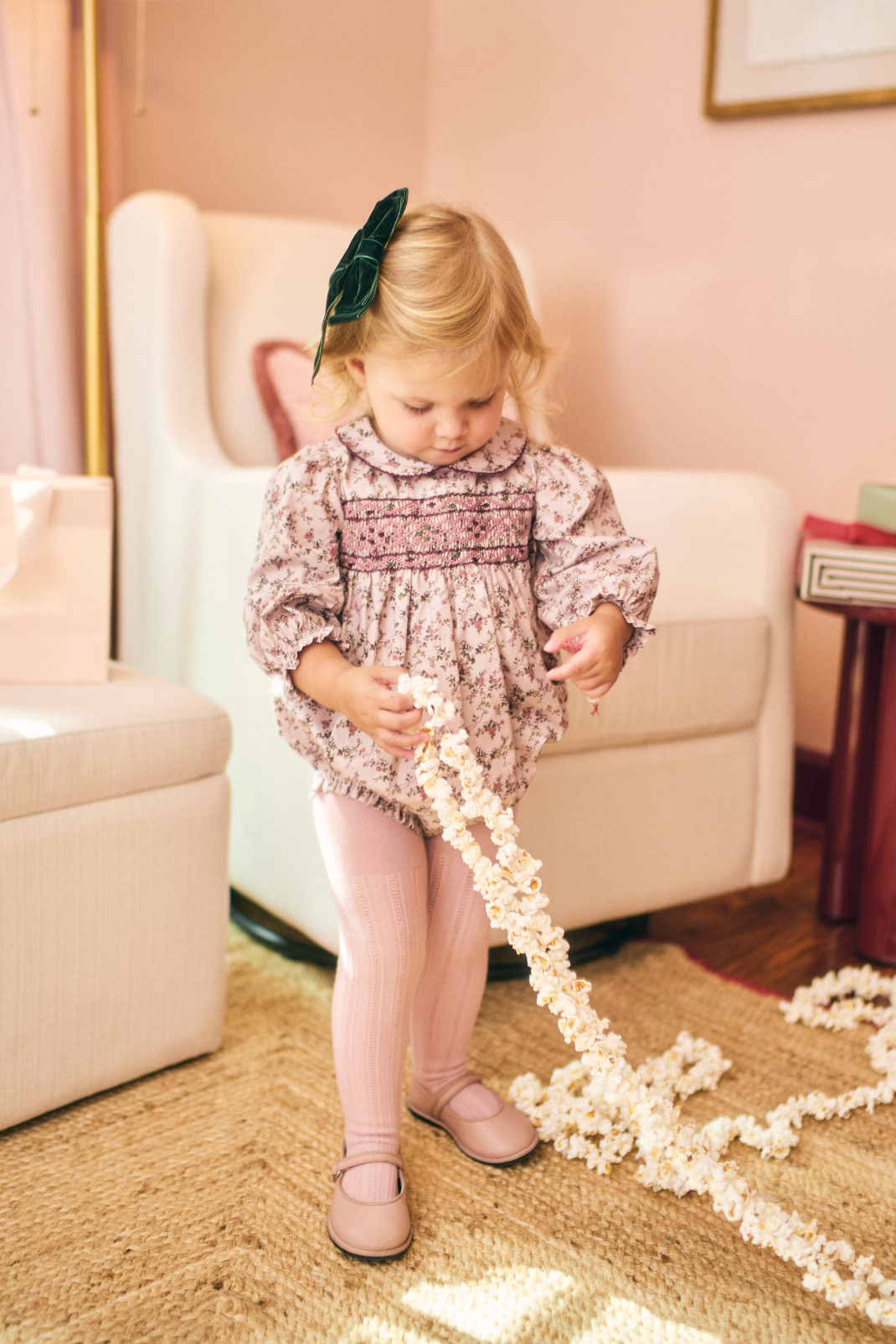 Young girl playing with popcorn in a living room