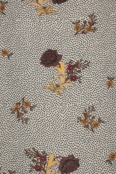 Floral patterned fabric with small flowers on a netural background