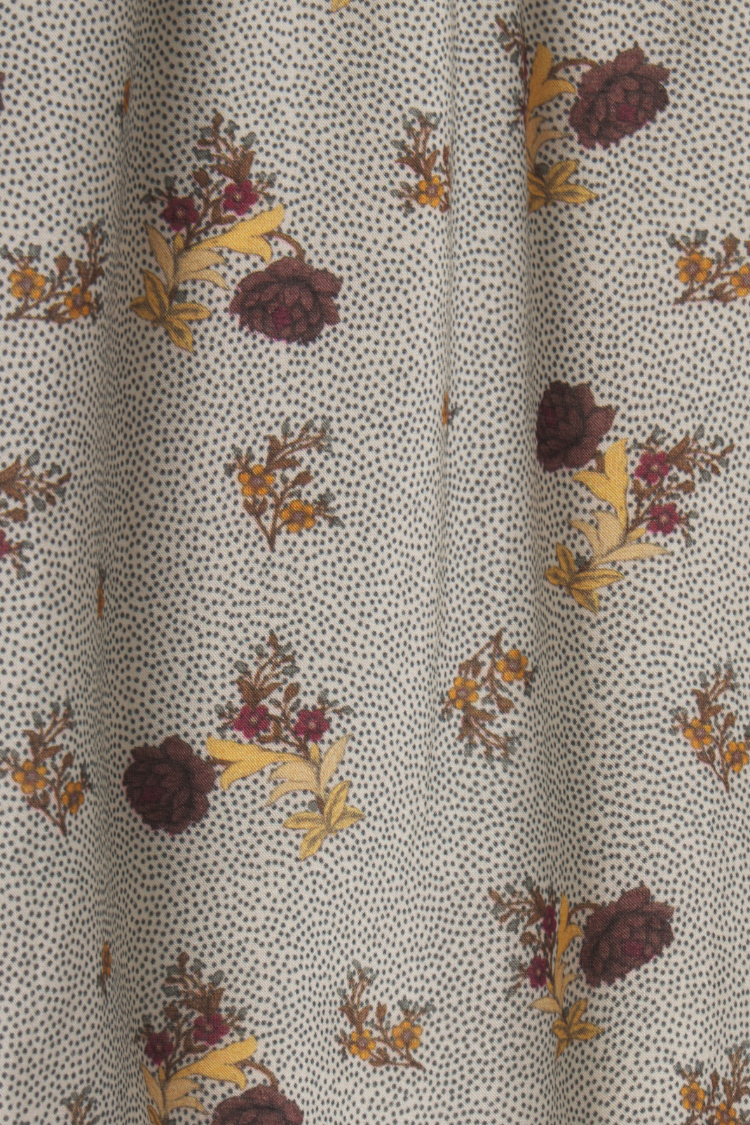 Close-up of fabric with floral pattern on a dotted background
