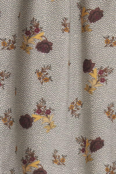 Close-up of fabric with floral pattern on a dotted background
