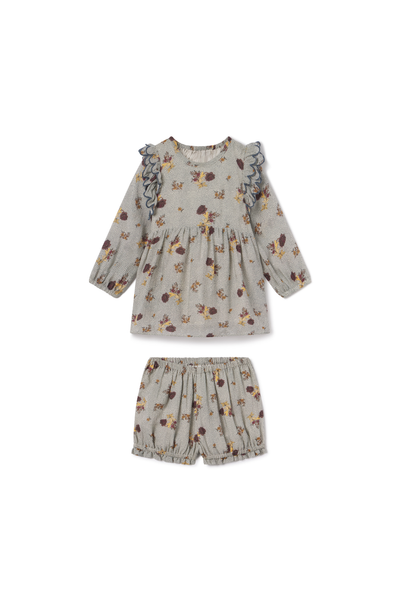 Children's floral dress and shorts set on a white background