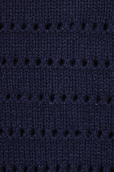 Close-up of a dark blue knitted fabric with a subtle pattern.