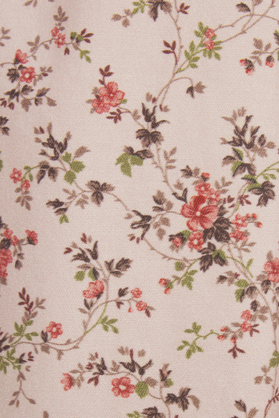Floral pattern with red flowers and green leaves on a beige background