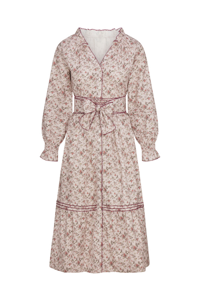 Floral patterned dress with a belt on a white background