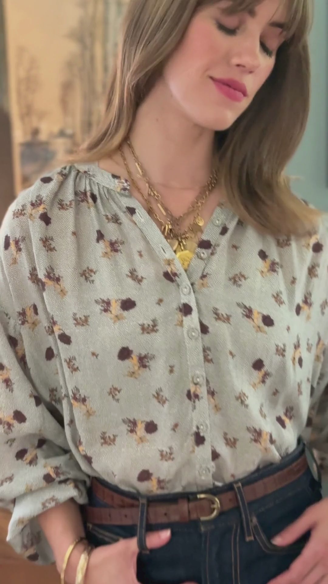 Video of a woman in a grey floral top