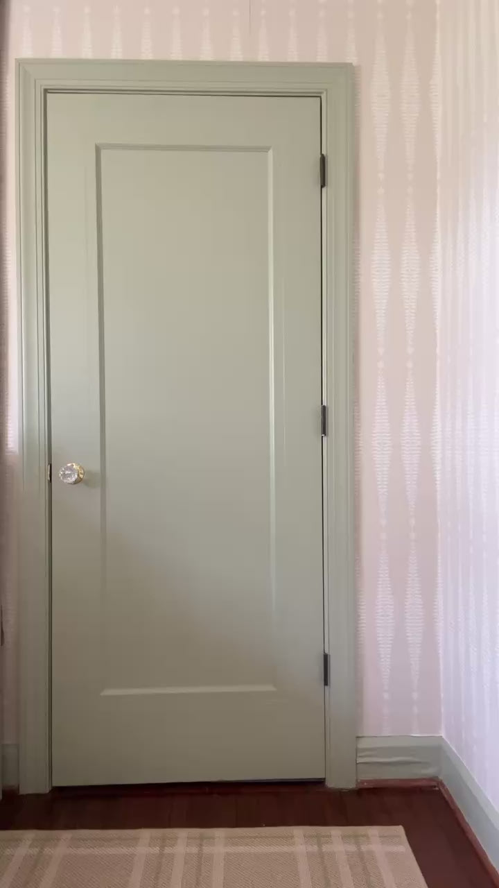 Video of  woman wearing a gray floral blouse styling her outfit