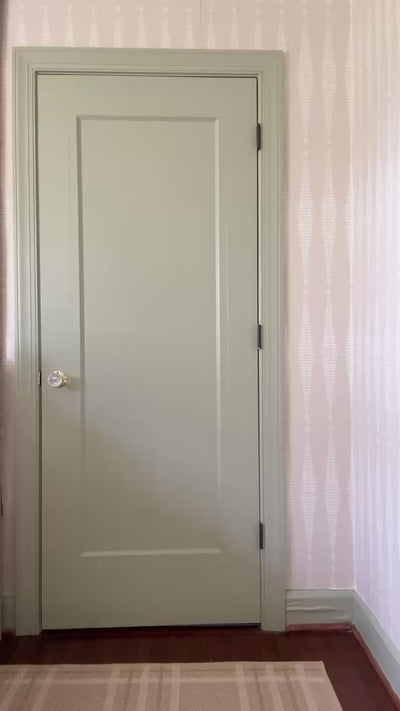 Video of  woman wearing a gray floral blouse styling her outfit