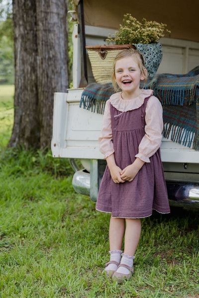 Lifestyle image of a little girl wearing the Cece Dress