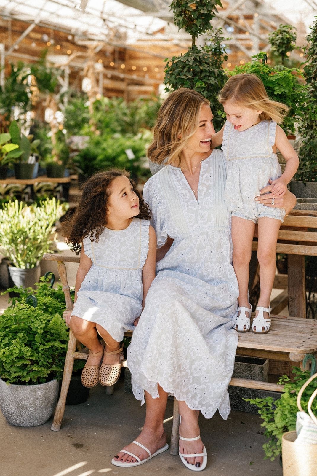Family shot of a mom and two little girls wearing pieces in the Sky Anemone Embroidery print