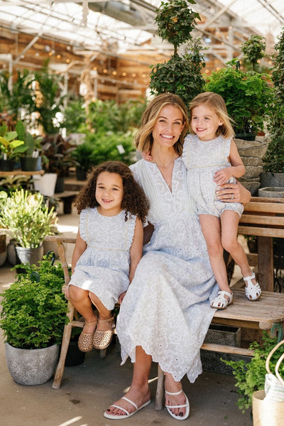 Lifestyle shot of a woman and her two daughters all wearing pieces in the Sky Anemone Embroidery