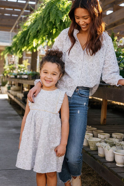 Lifestyle shot of a mother and daughter wearing pieces in the Sky Anemone Embroidery print