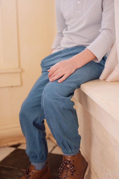Detailed shot of a little boy wearing the Devon Pant in medium blue