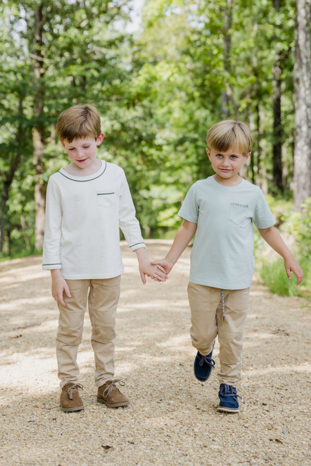 Lifestyle shot of two boys walking one wearing the Joey T-Shirt in Ivory with Thyme
