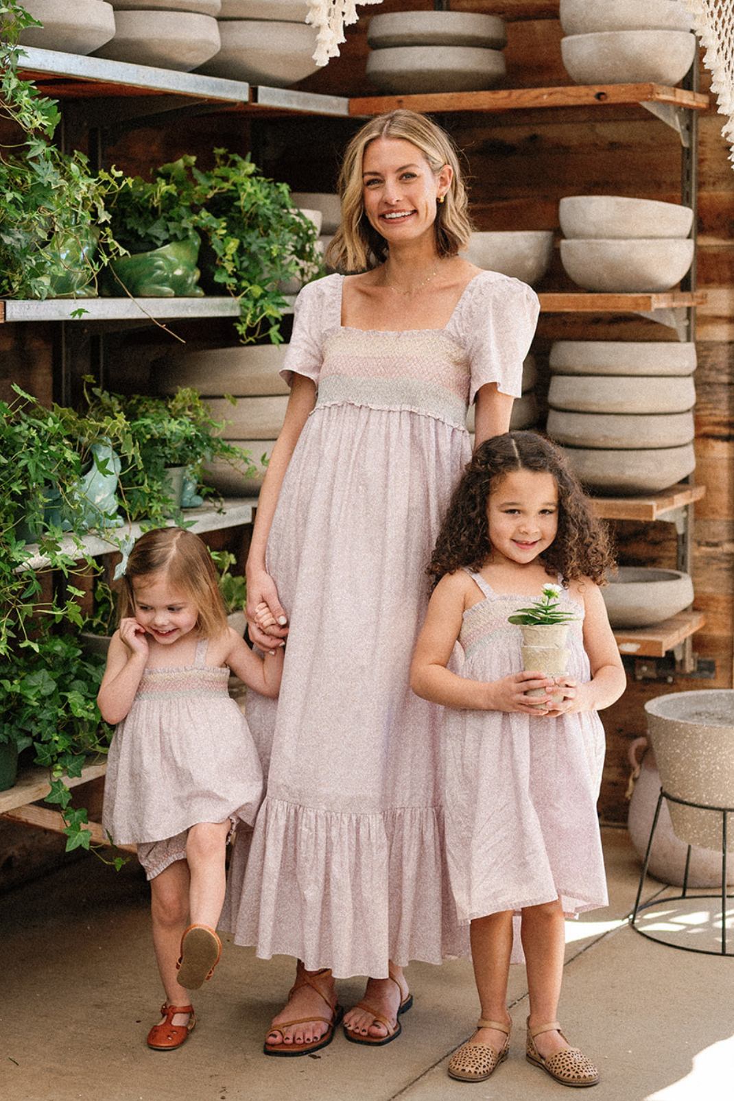 Lifestyle shot of a mother and her two daughters all wearing pieces in the Scattered Blooms print