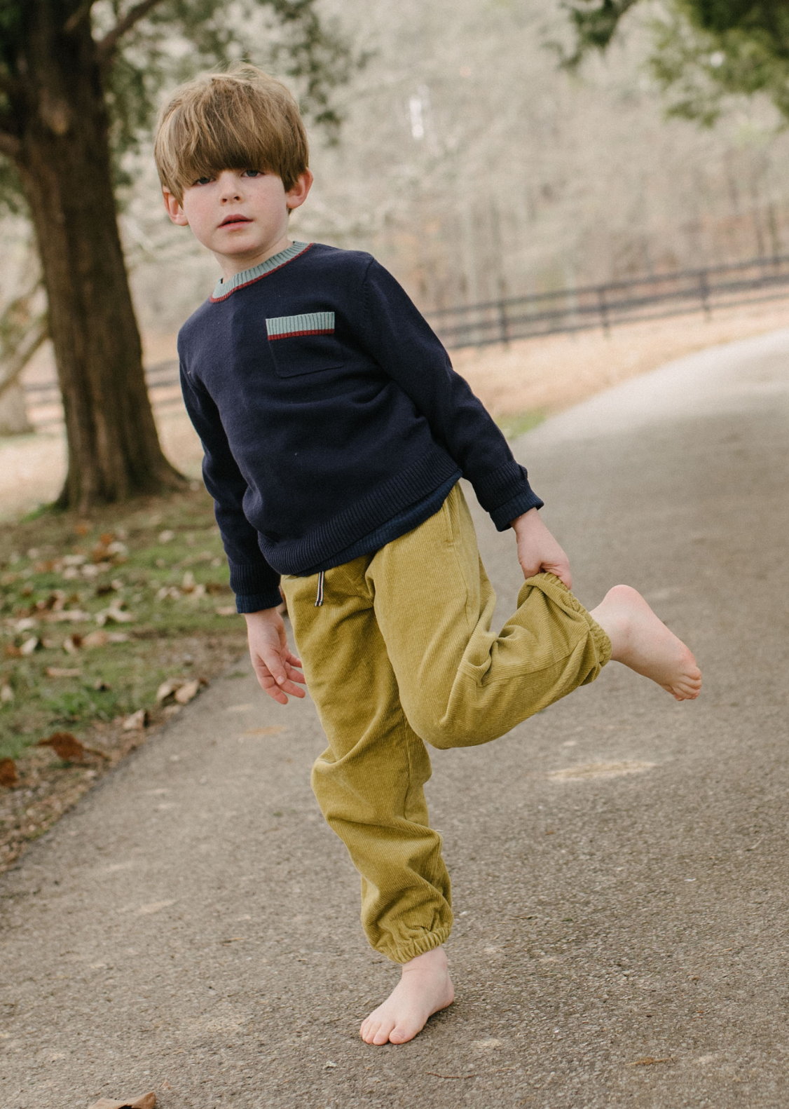 Boy wearing butterscotch corduroy jogger pants